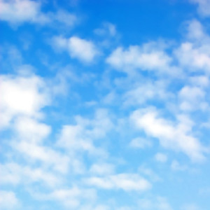 Editable vector illustration of fluffy white clouds in a blue sky made using a gradient mesh